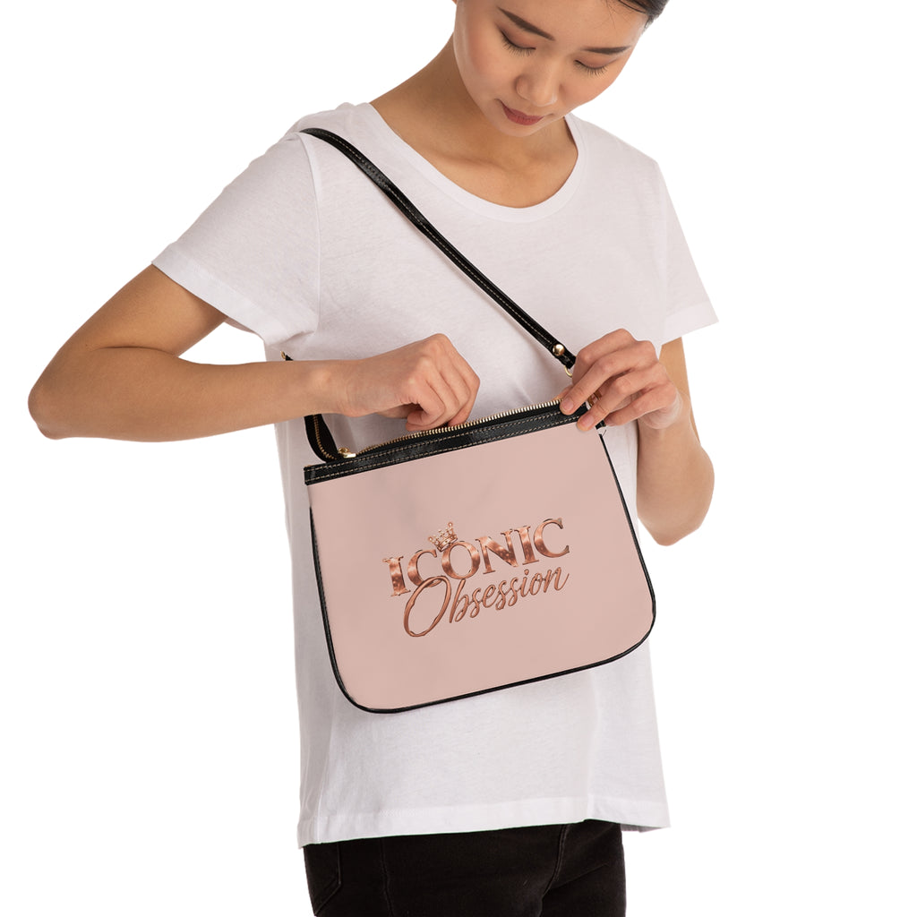 Model wearing the ICONIC Obsession Petite Shoulder Bag in blush over the shoulder