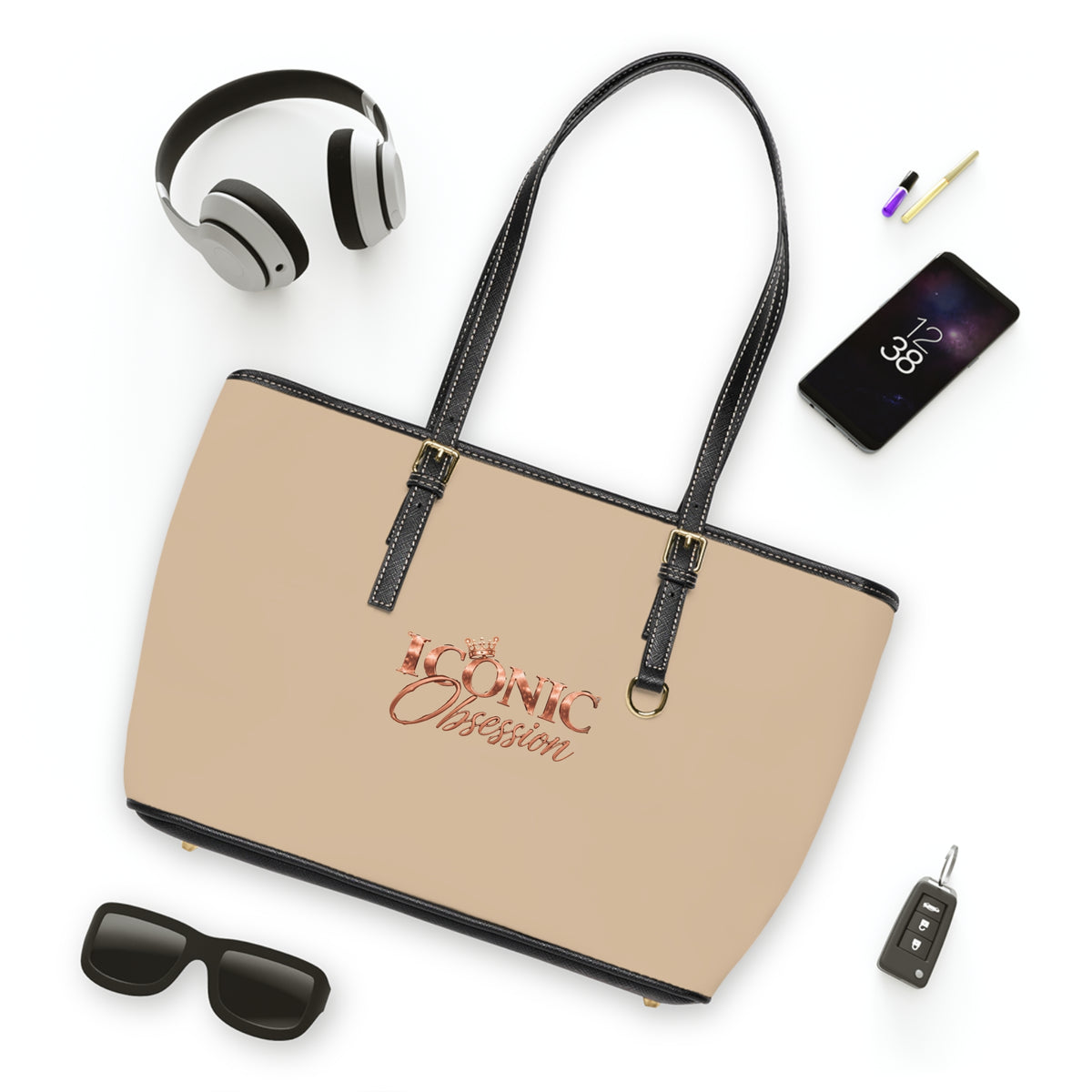 ICONIC Obsession Signature Tote in champagne, styled flat lay with sunglasses and headphones