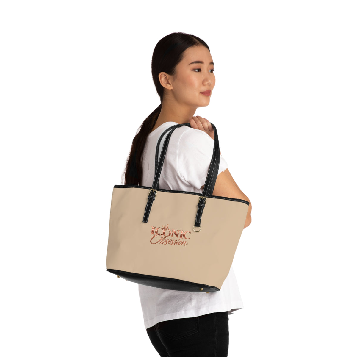 Model carrying the ICONIC Obsession Signature Tote in champagne on the shoulder