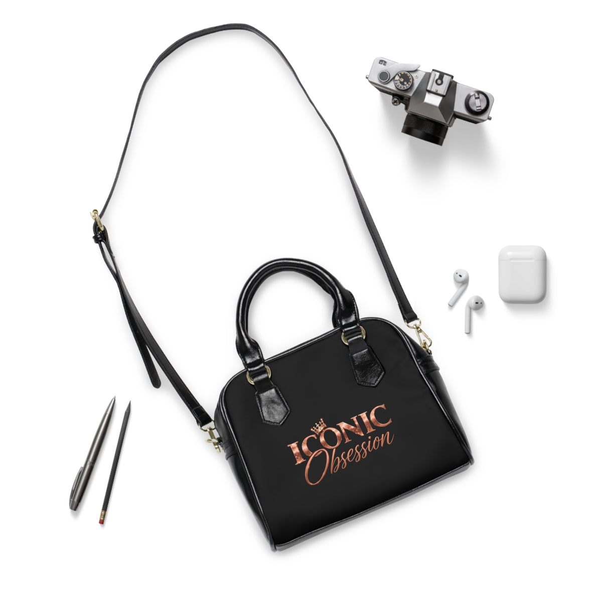 ICONIC Obsession Signature Shoulder Handbag in black with shoulder strap, styled flat lay