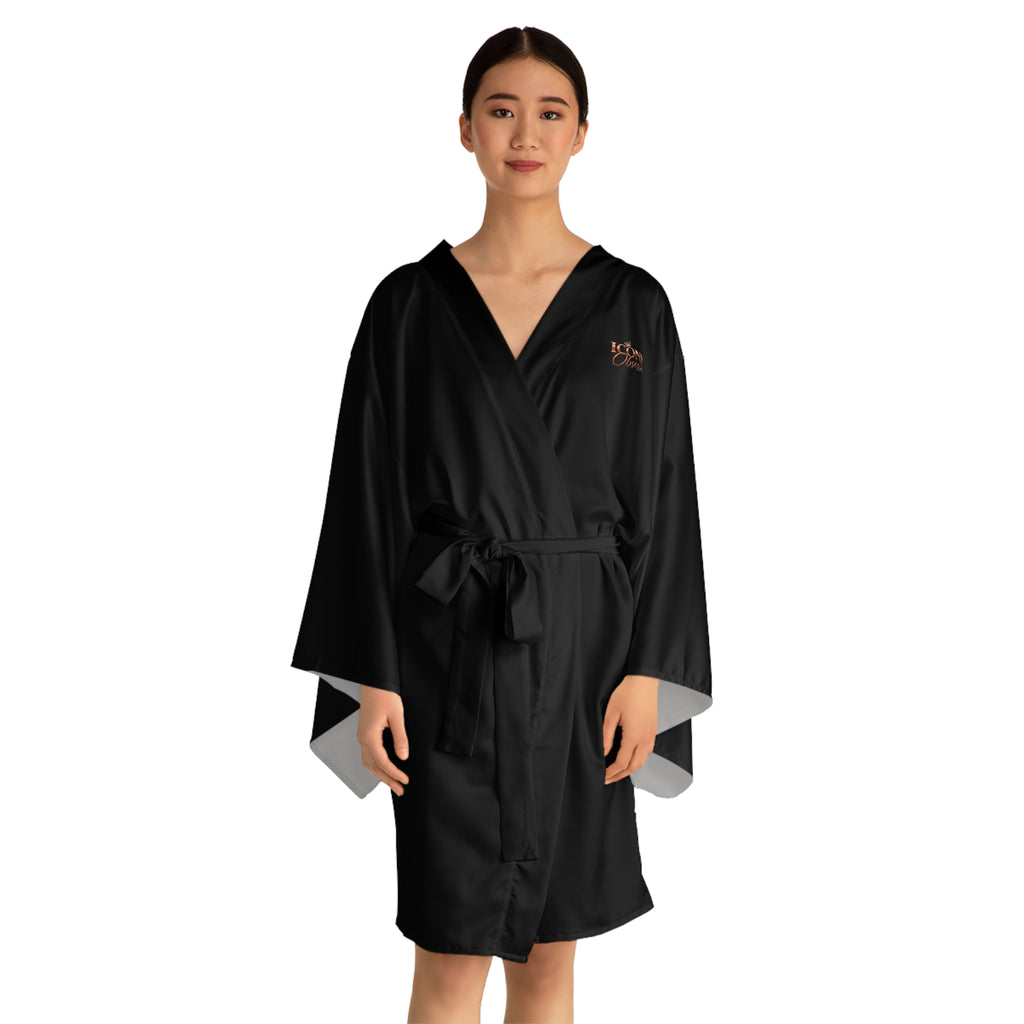 Model wearing the ICONIC Obsession black kimono robe, angled view showing the rose-gold chest logo