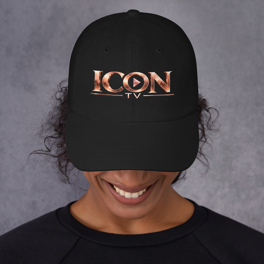 ICON TV Hat in black, worn by a model, front view with rose-gold logo