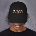 ICON TV Hat in black, worn by a model, front view with rose-gold logo