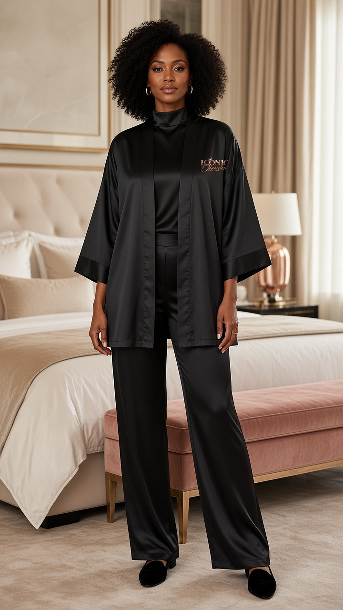 Full-length view of the ICONIC Obsession black silky kimono robe worn open over black loungewear in a luxe ivory bedroom