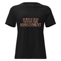 Subtle Was Never the Assignment Tee in black, front view with rose-gold lettering